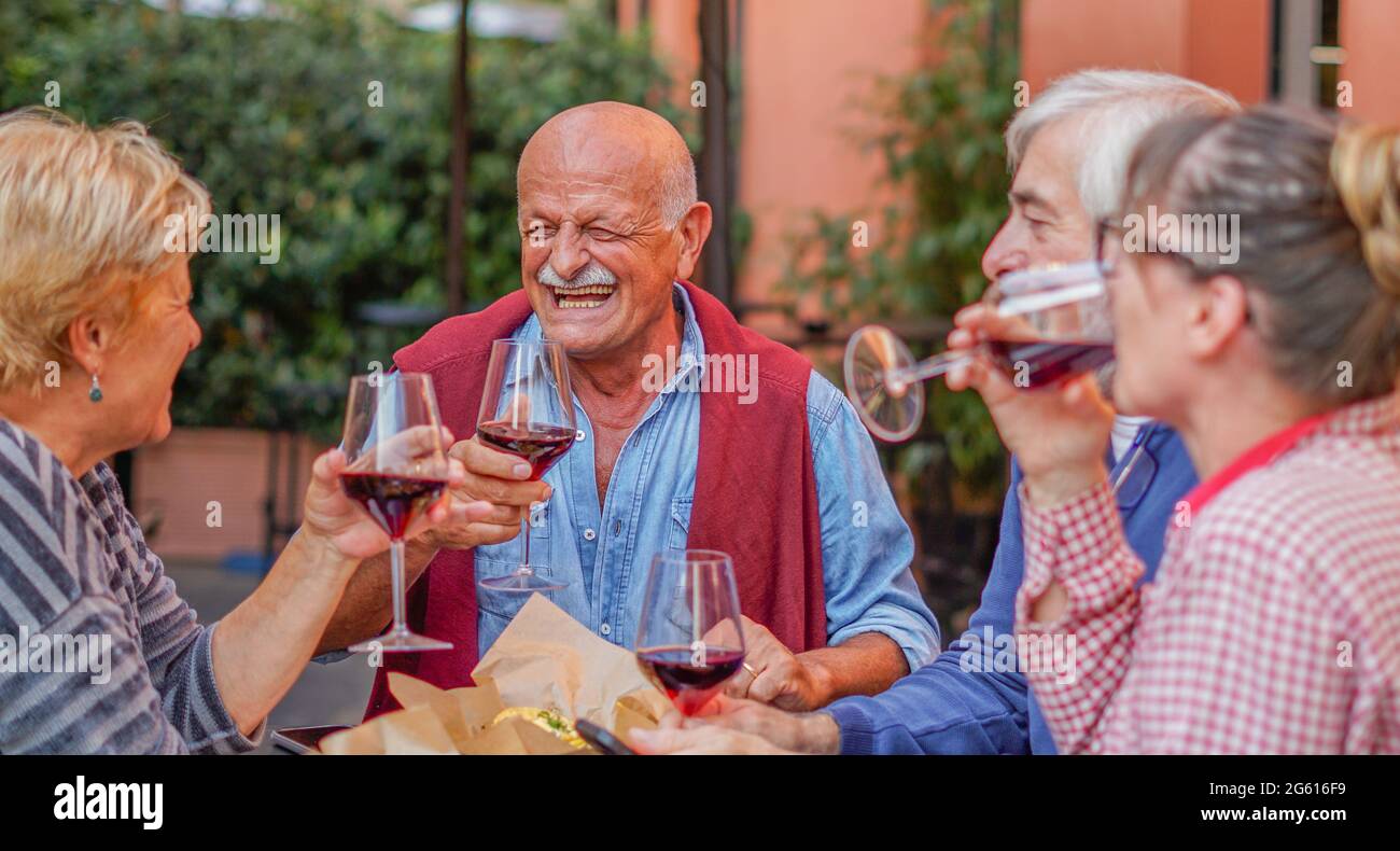 Group of old people eating and drinking outdoor - Seniors having fun outside Stock Photo