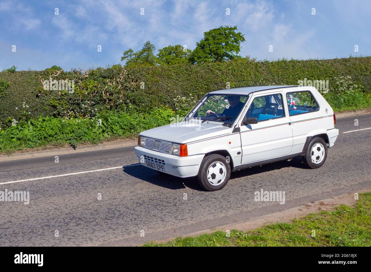 1990 90s white Fiat Italia 90 4 speed manual 2dr, 769 cc petrol small city car en-route to Capesthorne Hall classic May car show, Cheshire, UK Stock Photo