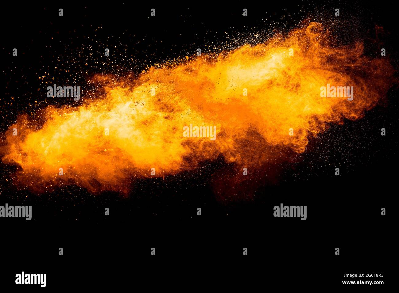 Orange color powder explosion on black background. Stock Photo