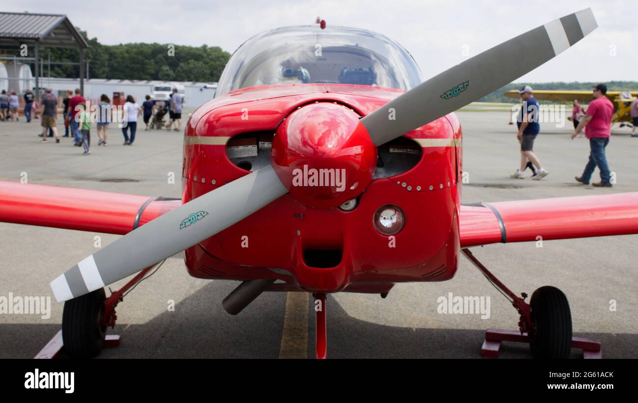 A Front View of a Small Red Single Engine Airplane Stock Photo