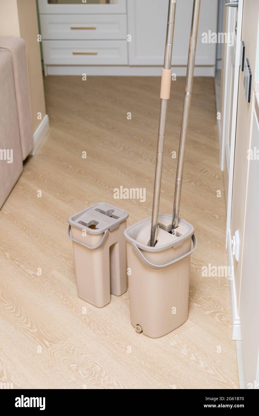 Modern buckets with mops. Cleaning of premises. Closeup Stock Photo