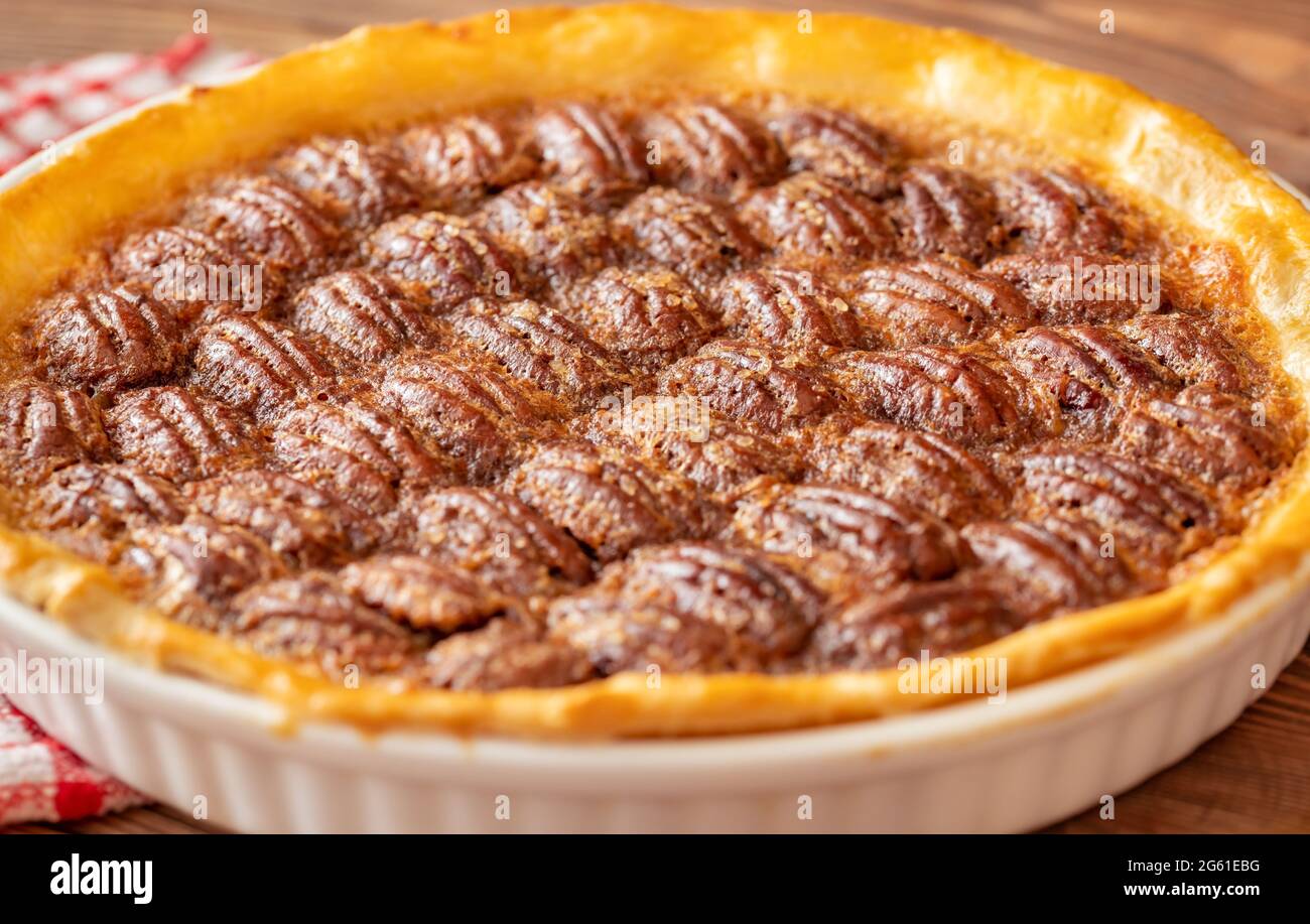 Pecan pie - traditional southern US dessert on wooden table Stock Photo