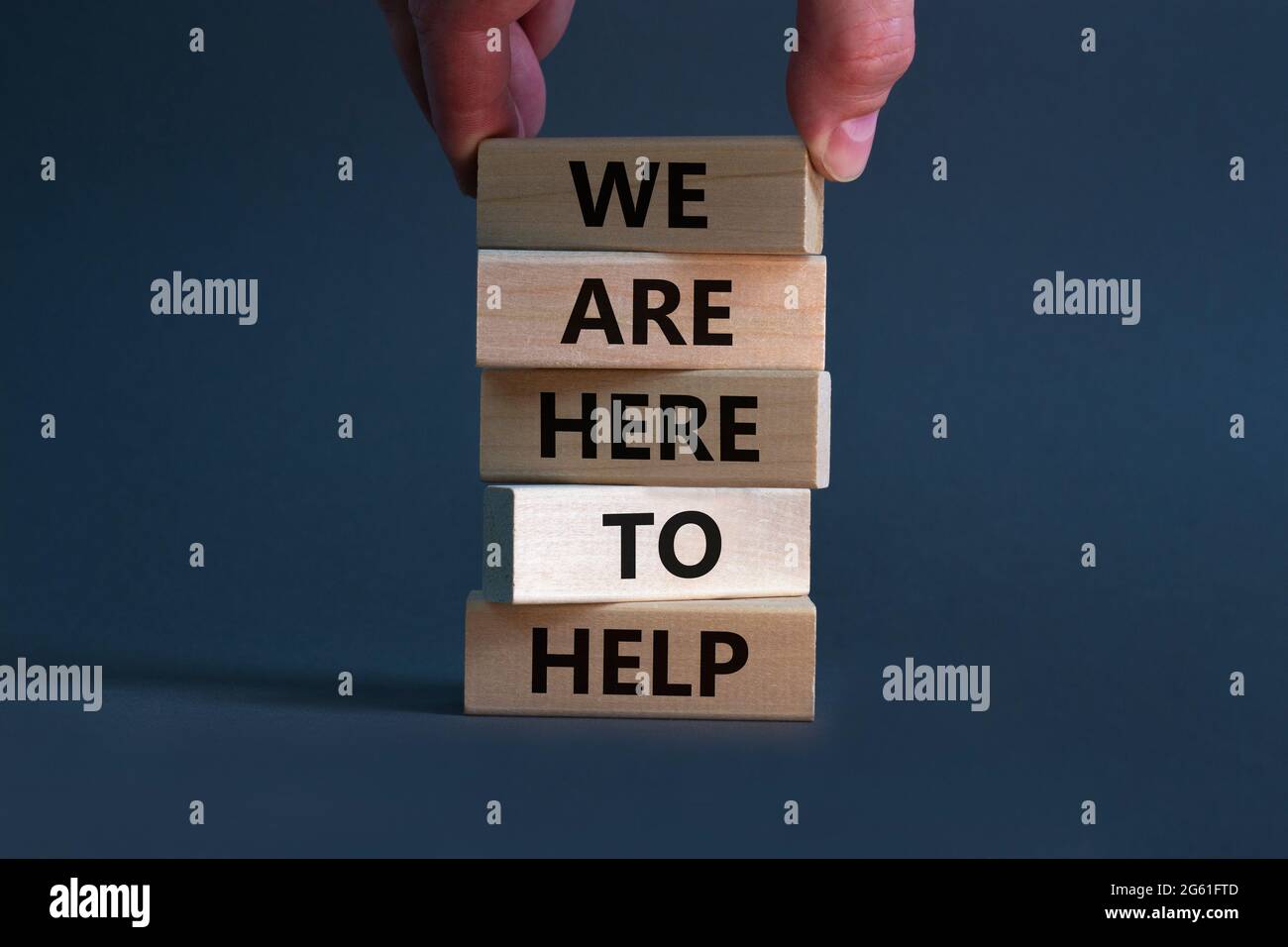 We Help Symbol Support and help symbol. Wooden blocks with words 'we are here to help ...