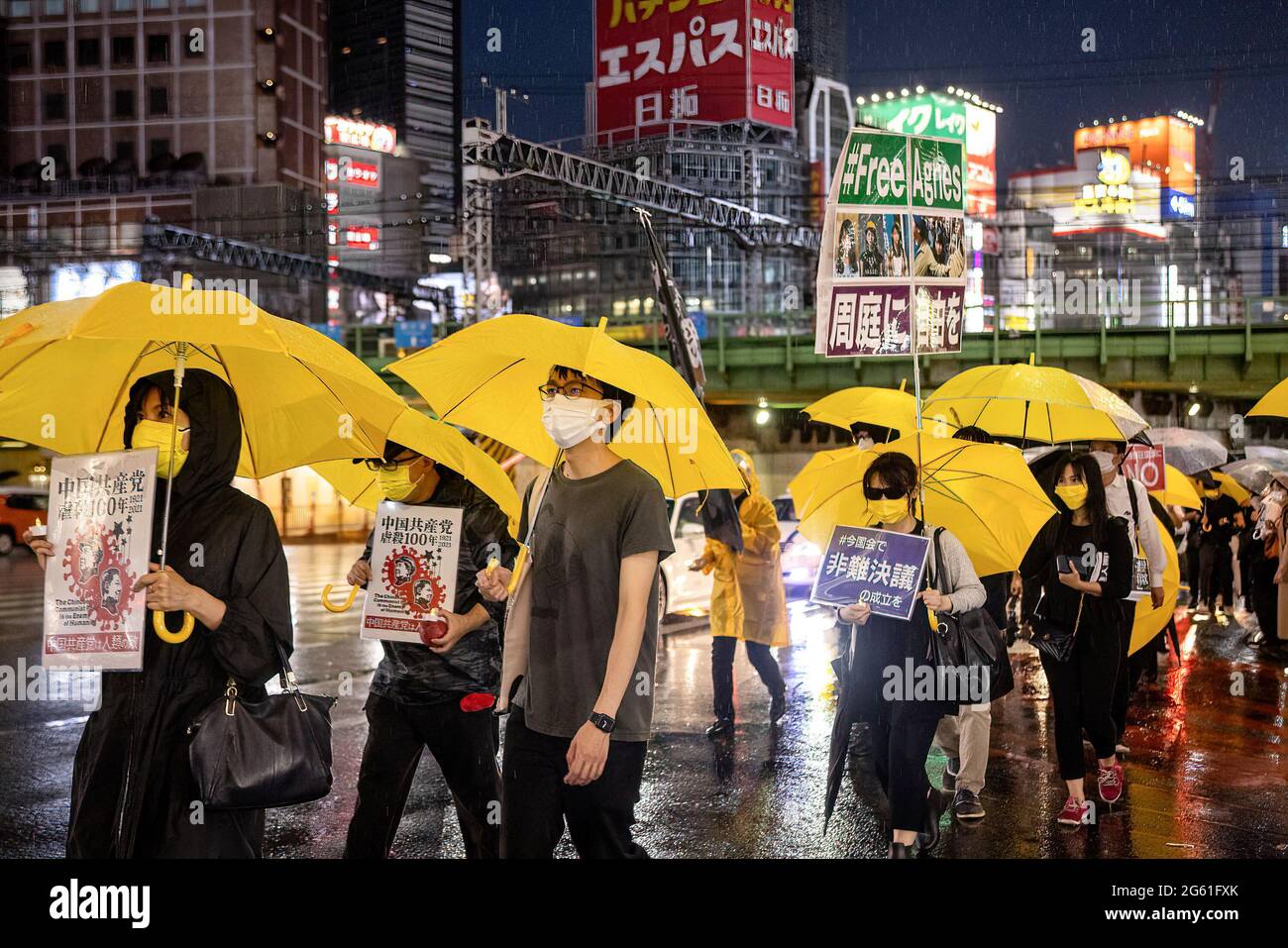 Tokyo Japan 01st July 2021 Protesters Marching With Yellow tokyo-japan-01st-july-2021-protesters-marching-with-yellow
