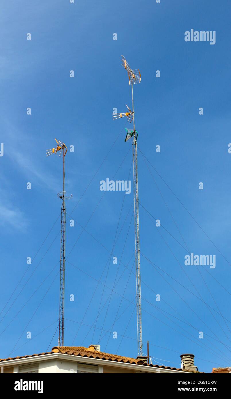 Two tall tv aerial masts with a blue sky in Zaragoza Aragon Spain Stock Photo