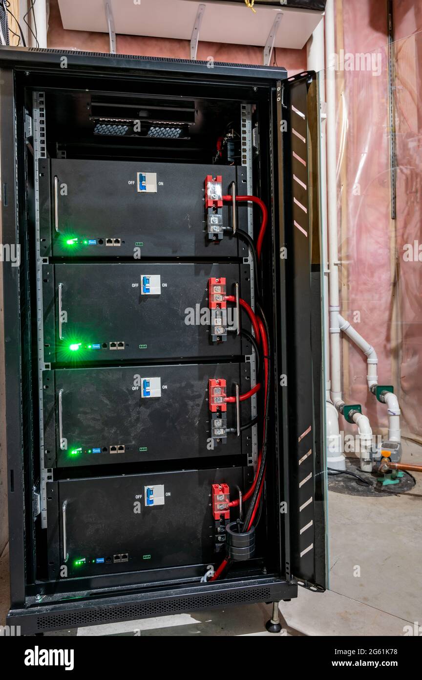 bank of electric batteries in a residential house used for backup power or in conjunction with solar energy storage Stock Photo