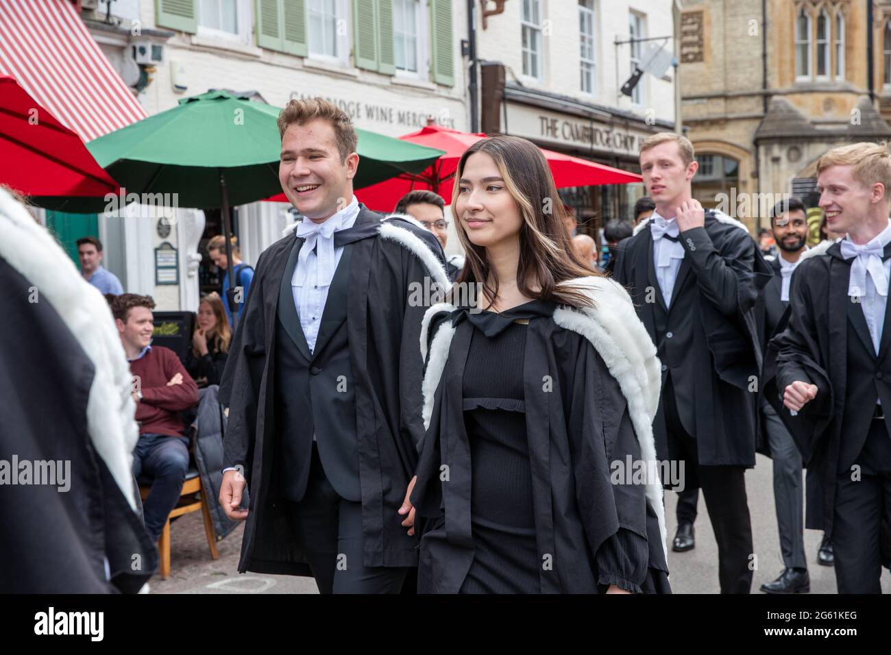 Picture dated  July 1st 2021 shows students from  Queens’  Cambridge on their graduation day which has returned after the ceremony was cancelled last year due to the Coronavirus pandemic.  Students dressed in black gowns as the traditional Cambridge University graduation ceremonies took place – after they were cancelled last year due to the Coronavirus pandemic. The students paraded into historic Senate House to collect their degrees from the prestigious university. Family and friends would normally watch the ceremony inside the Senate House, but this year they had to wait outside due to Covid Stock Photo