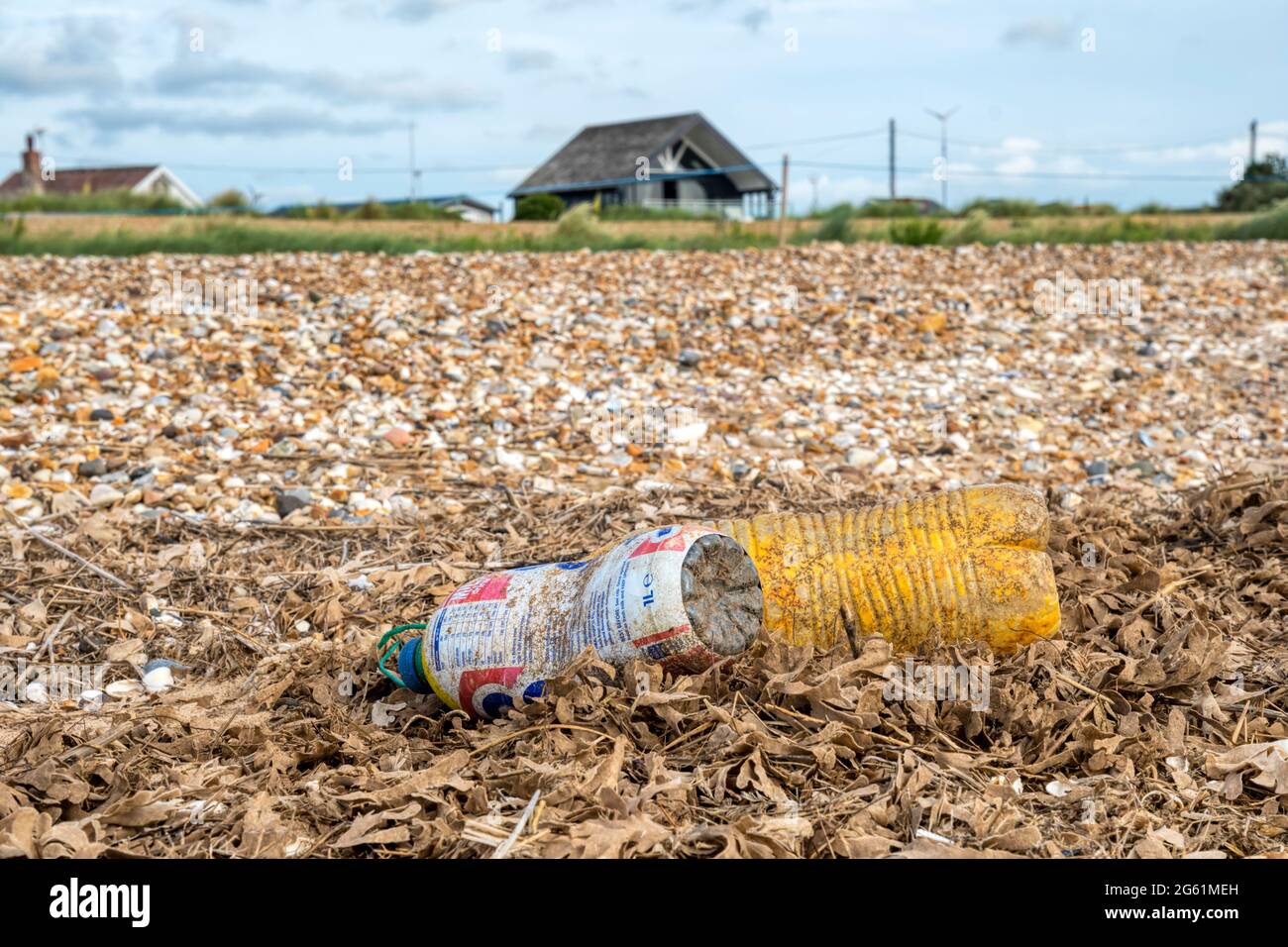 Plastic drinks bottles washed up on the high tide line on the shore of the Wash in Norfolk. Stock Photo