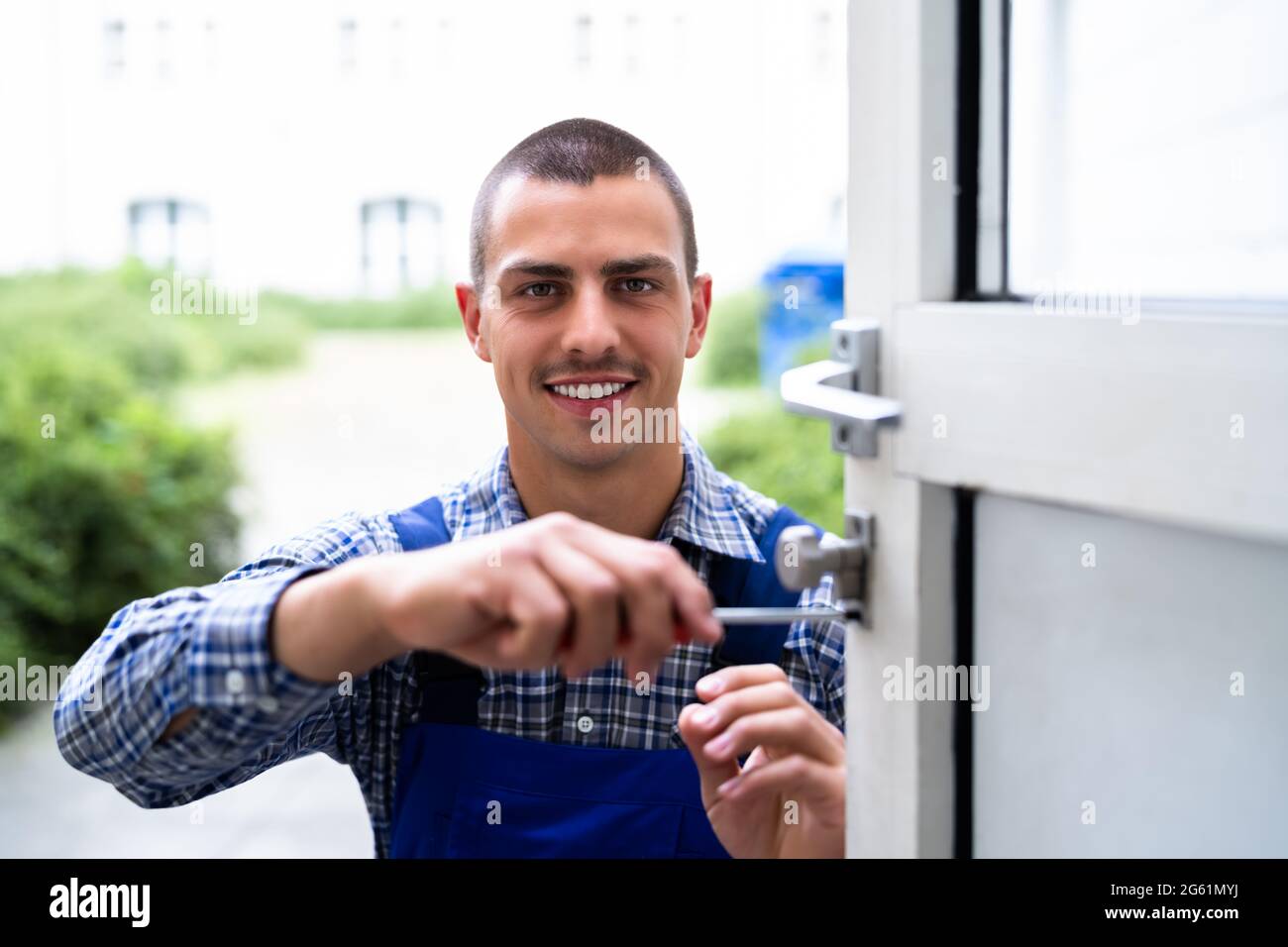 Locksmith Lock Door Repair. Worker Changing And Cylinder Stock Photo