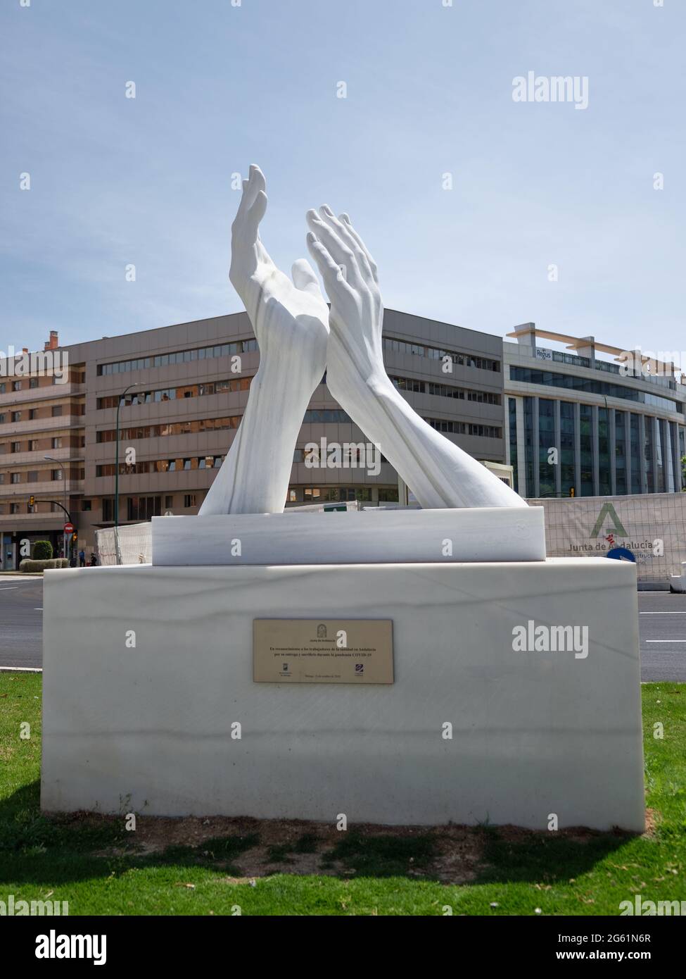 Clapping hands. Sculpture that recognizes the work of health workers and other essential workers to contain the Covid. Malaga, Spain Stock Photo