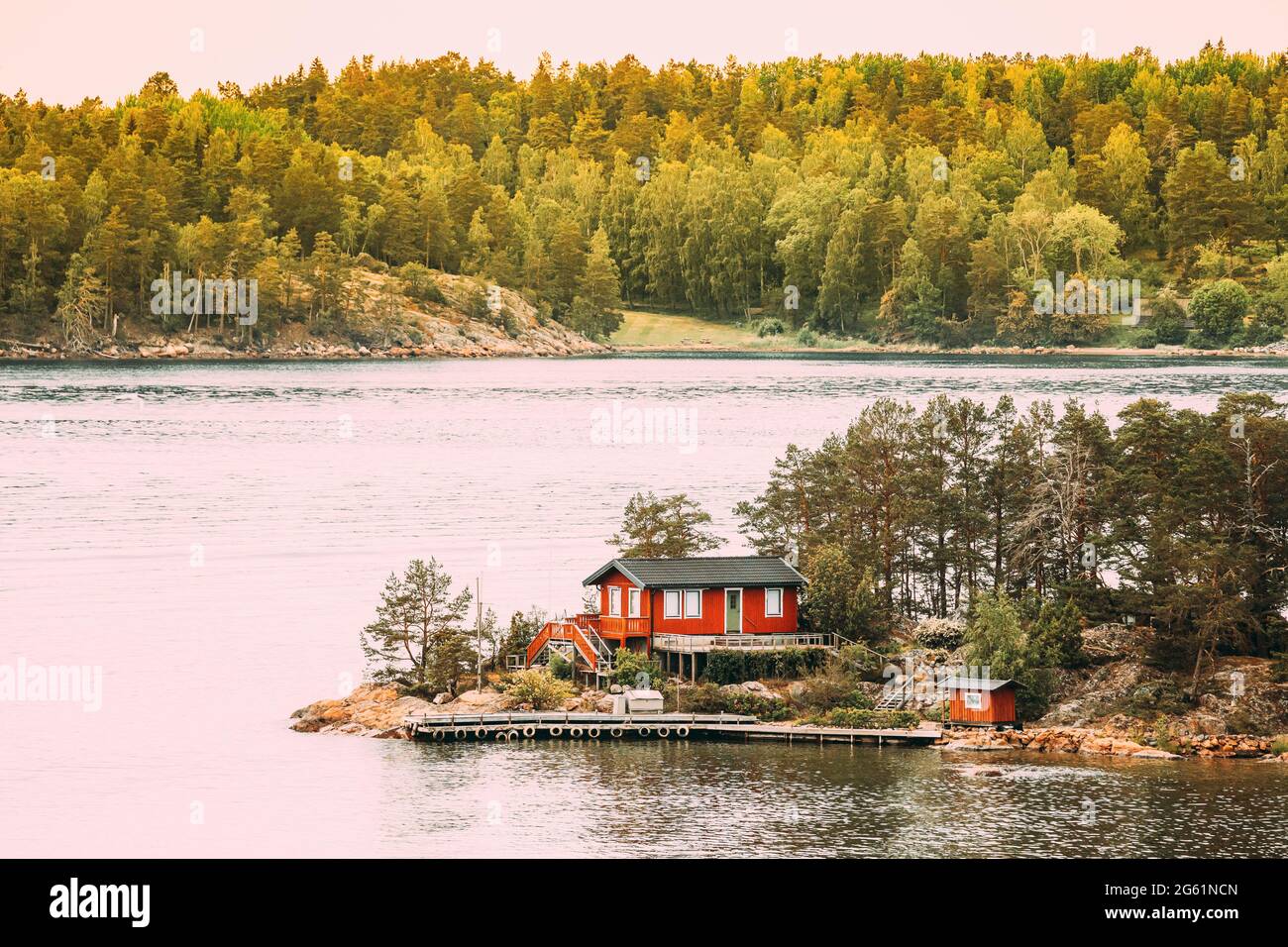 Sweden. Many Beautiful Red Swedish Wooden Log Cabin House On Rocky Island  Coast In Summer. Lake Or River Landscape Stock Photo - Alamy