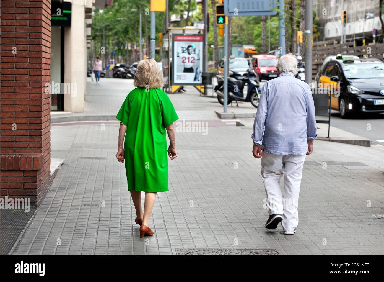 Strange old couple walking like zombies in the street. Barcelona, Spain. Stock Photo