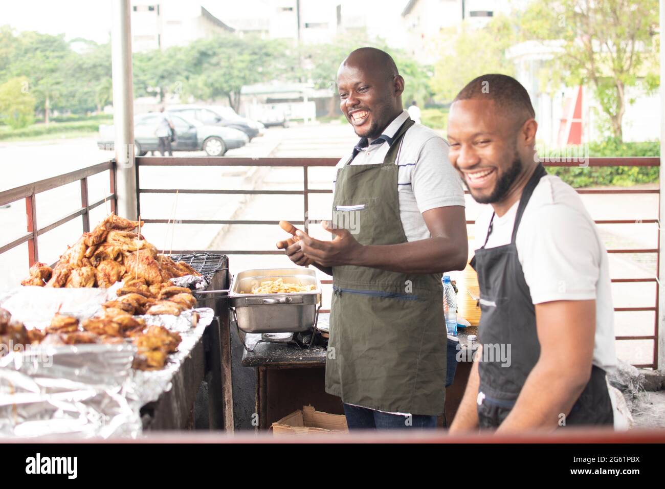 african man selling barbeque chicken Stock Photo - Alamy