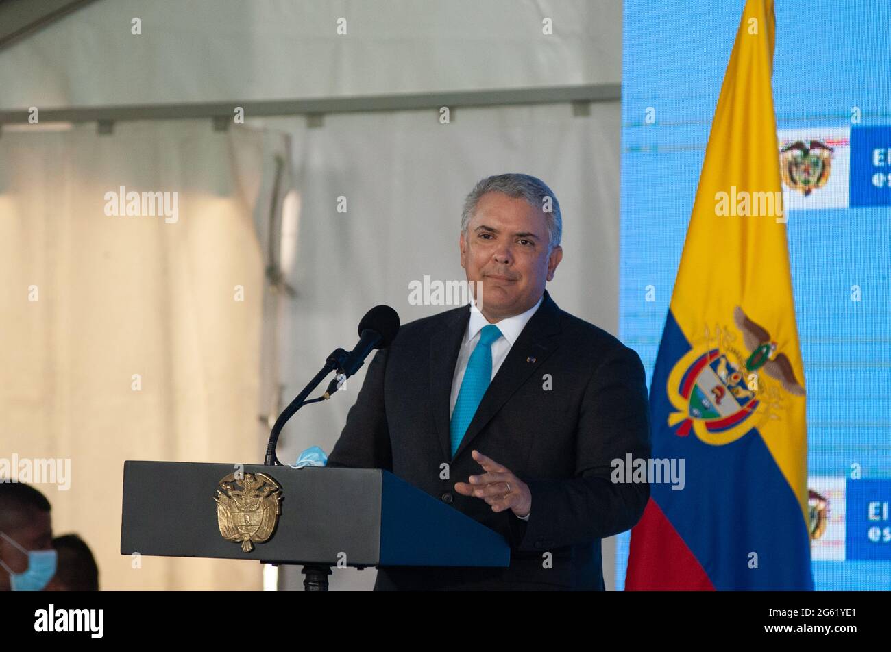 Colombia's president Ivan Duque stands and signs Colombia's national anthem during a press conference regarding the first line of Bogota's metro syste Stock Photo