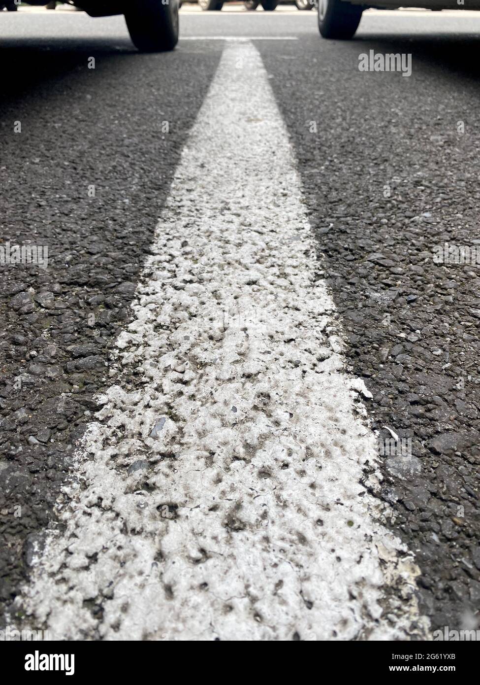 White parking lane line with two wheels on background Stock Photo