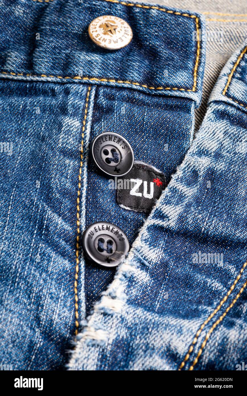 Button fly of an old faded ZU+Elements denim casual men's jeans Stock Photo