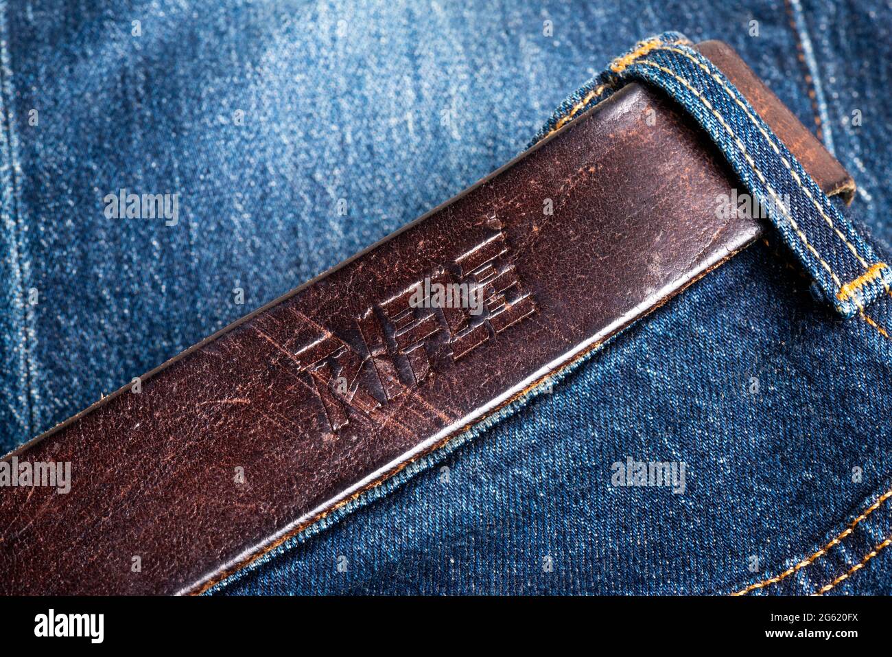 Rifle vintage belt on blue jeans Stock Photo