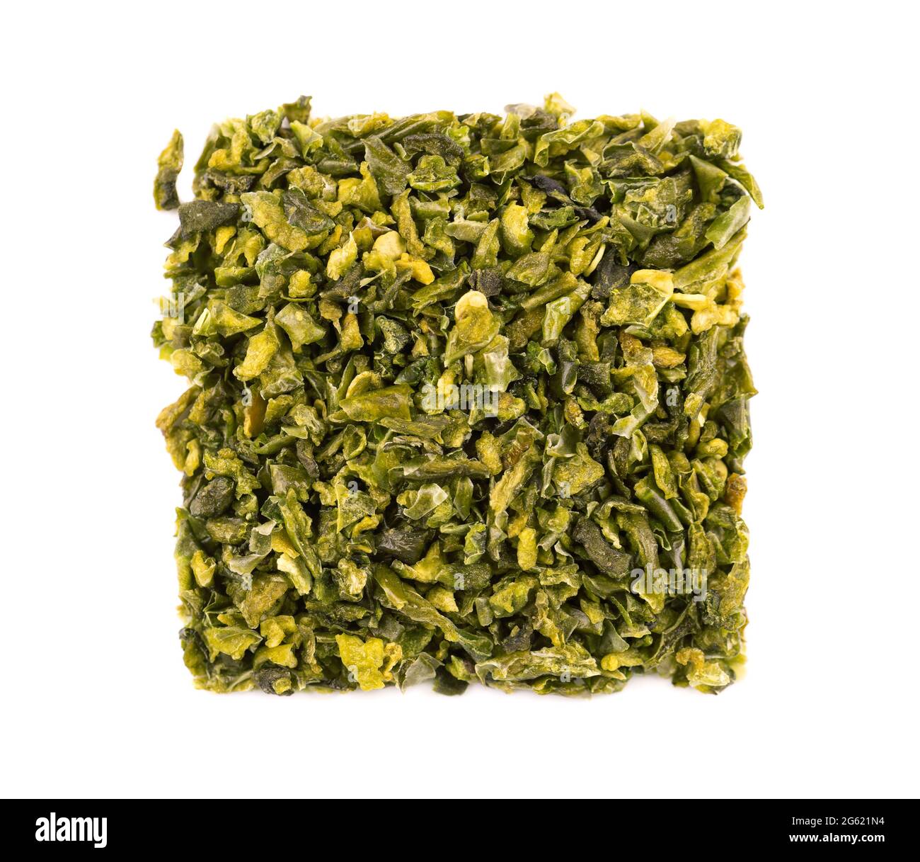 Dried green paprika flakes with seeds isolated on white background