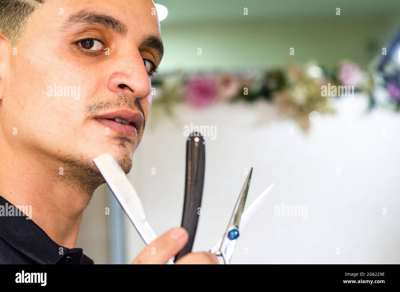 Barber Shop. Barber holds a razor to shave his beard Stock Photo Alamy