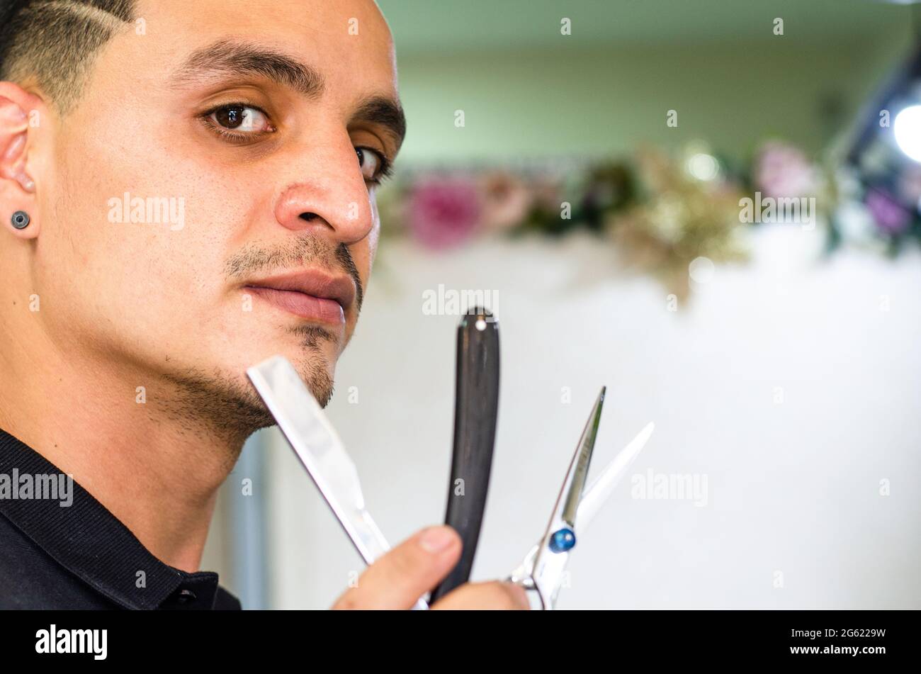 Barber Shop. Barber holds a razor to shave his beard Stock Photo Alamy