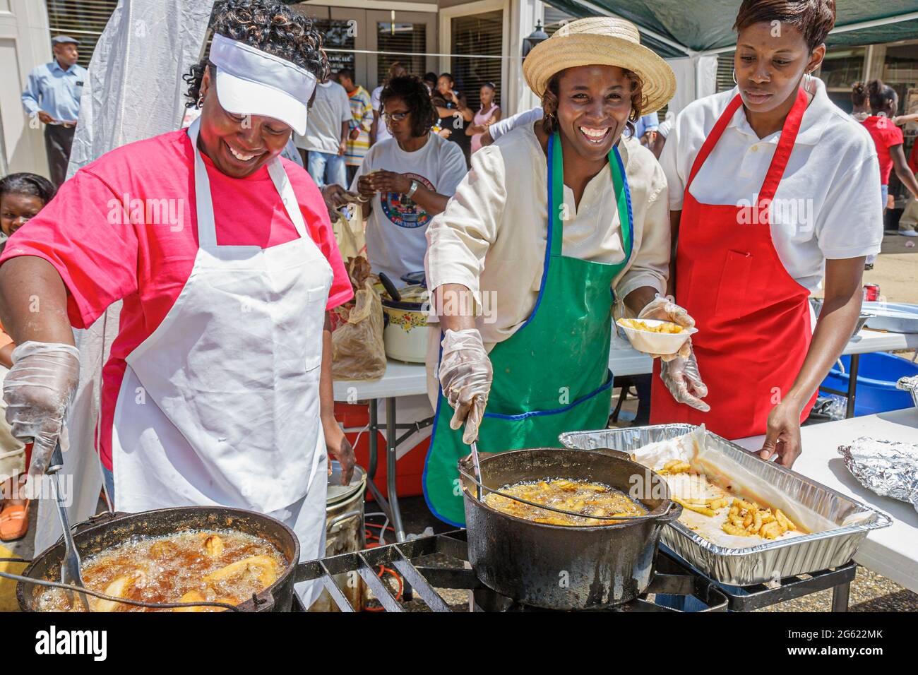 Alabama Union Springs Prairie Street Chunnenuggee Fair,cooking making fried chicken Black woman female women cooks volunteers friends, Stock Photo