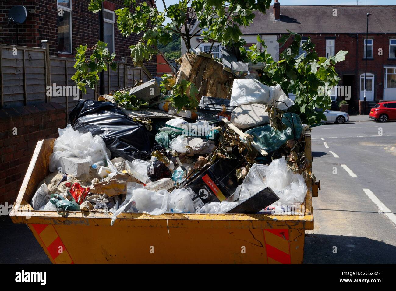 Builders skip full of waste material, trash, waste plastic wrapping