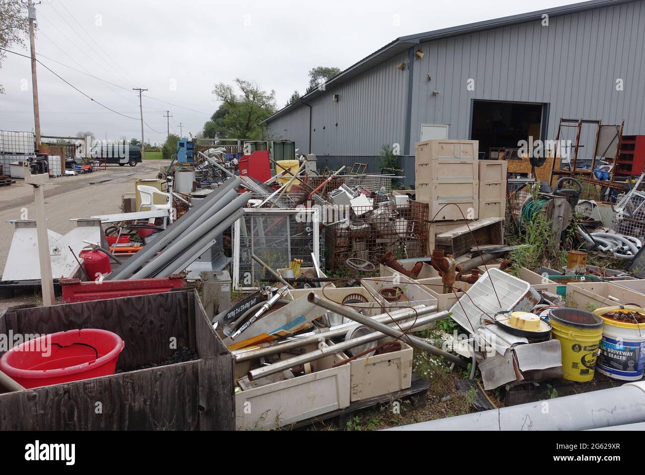 Bins of surplus scrap sit outside of Delaney's Surplus sales south of