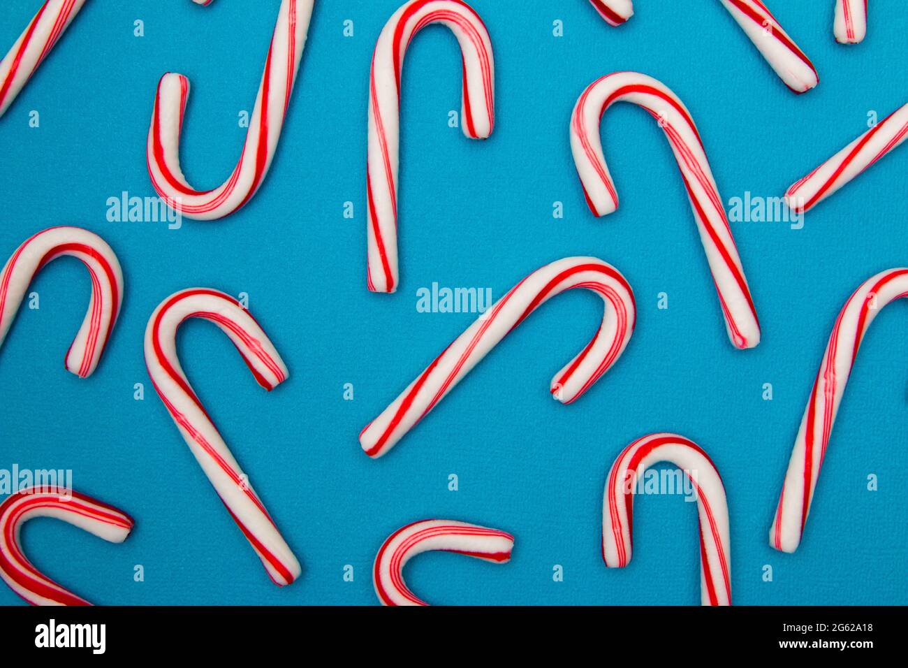 A Candy Cane Background on a Blue Background Stock Photo Alamy