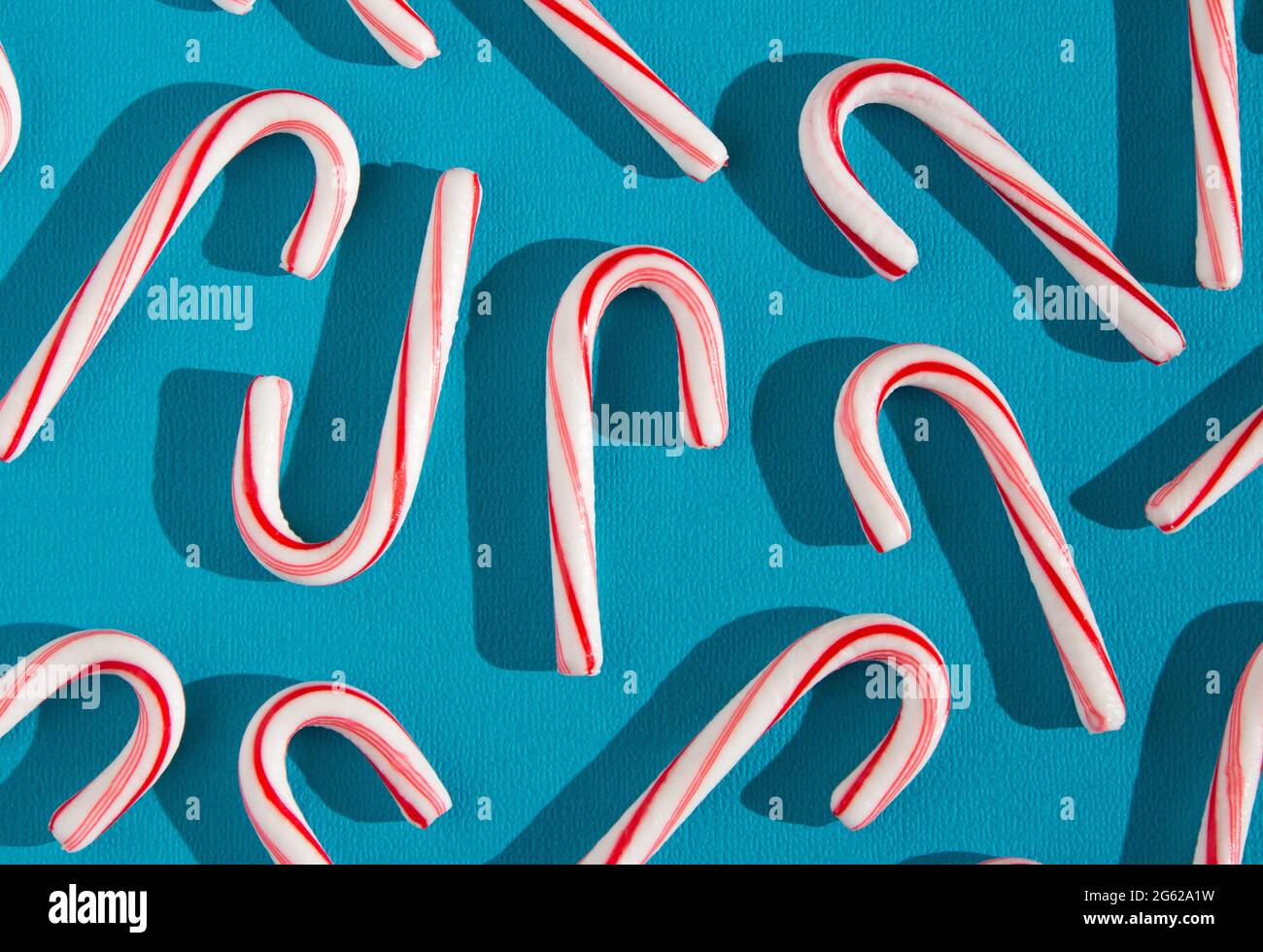 A Candy Cane Background on a Blue Background Stock Photo Alamy