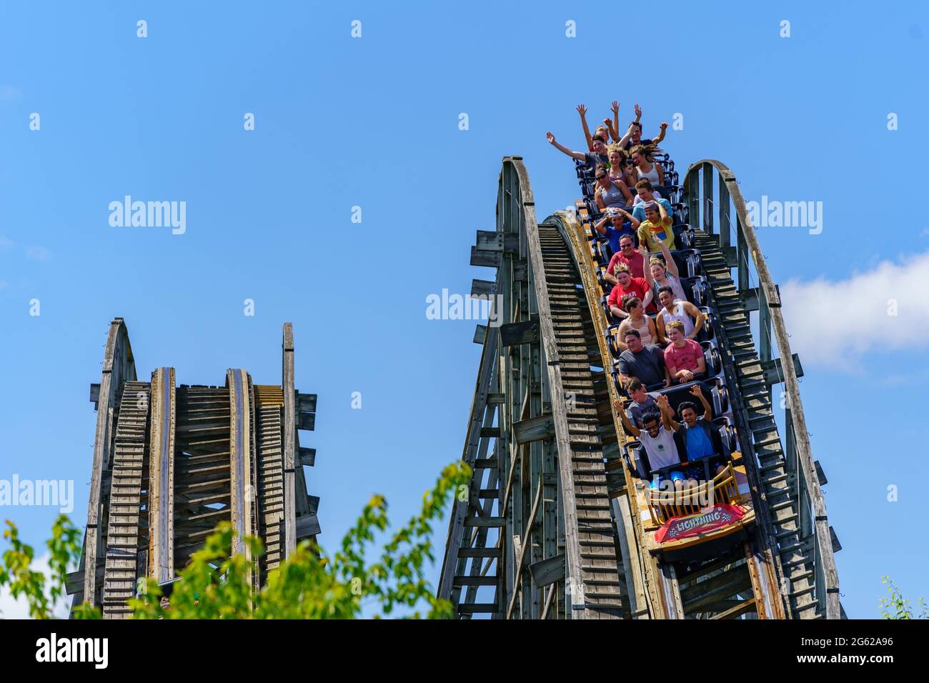 Hershey, PA, USA – June 27, 2021: Visitors at Hersheypark ride the first racing and dueling double-track wooden roller coaster in the United States. Stock Photo