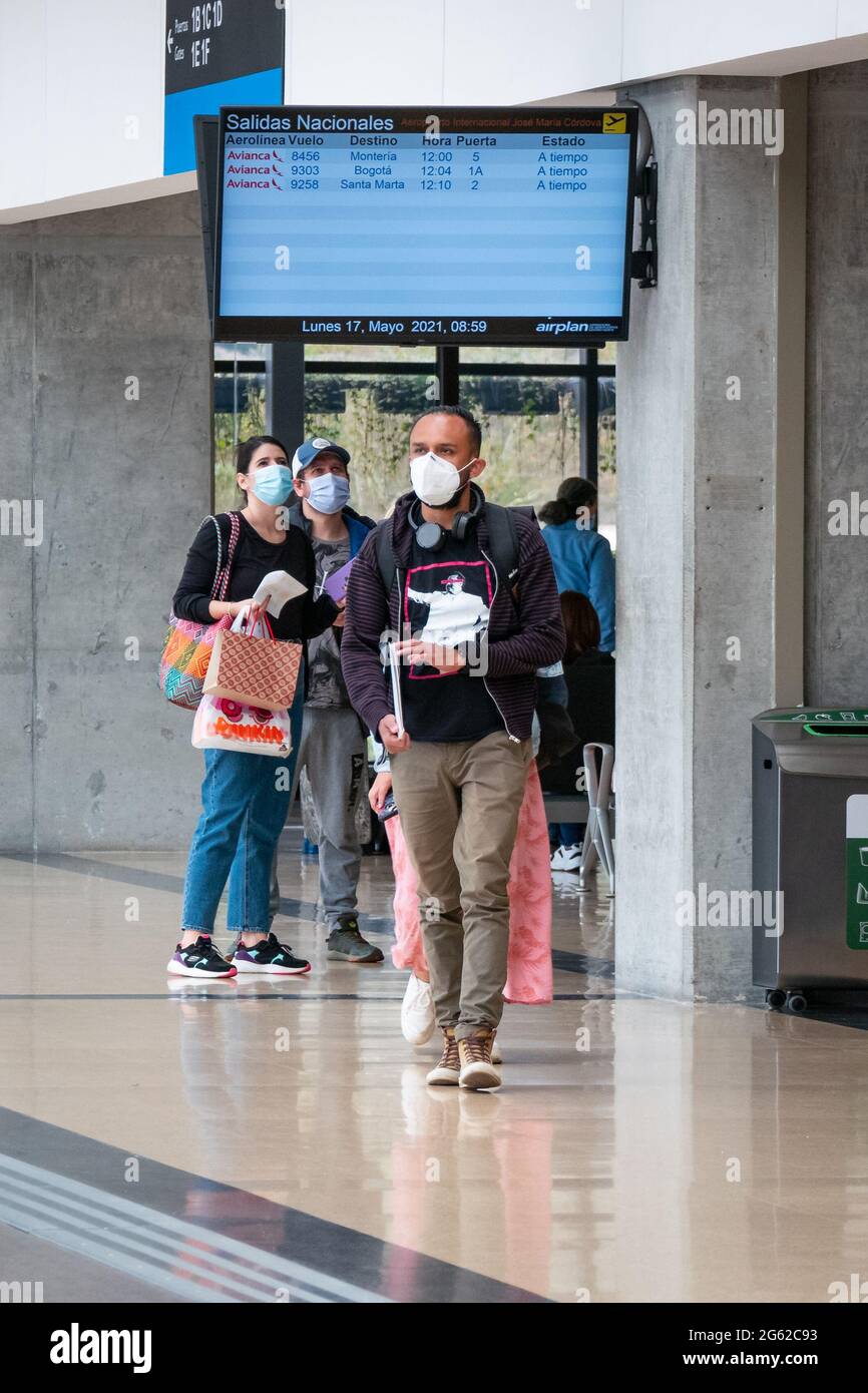 Medellin, Antioquia, Colombia - May 17 2021: Latin People with Mask Walks with their Bags at the Jose Maria Cordova Airport Terminal Stock Photo