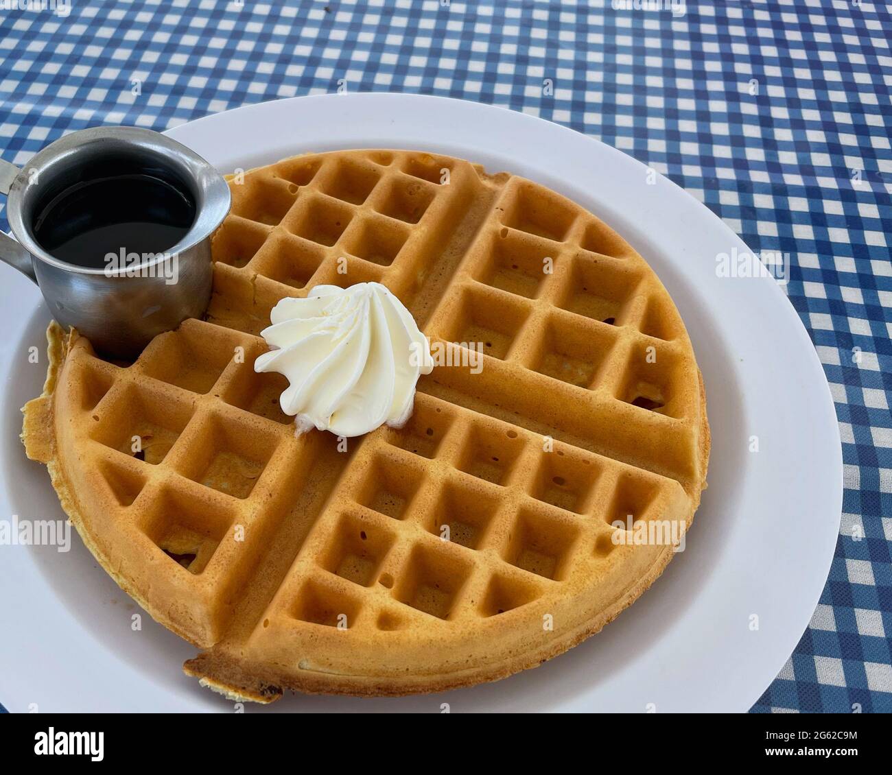 A crispy on the outside and soft on the inside waffle with butter and