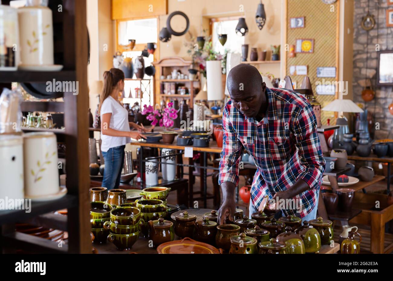 Man choosing earthenware Stock Photo Alamy