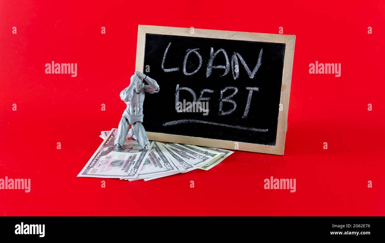 Financial problem concept. Loan Debt Concept. Selective focus on the board hand written loan debt Stock Photo