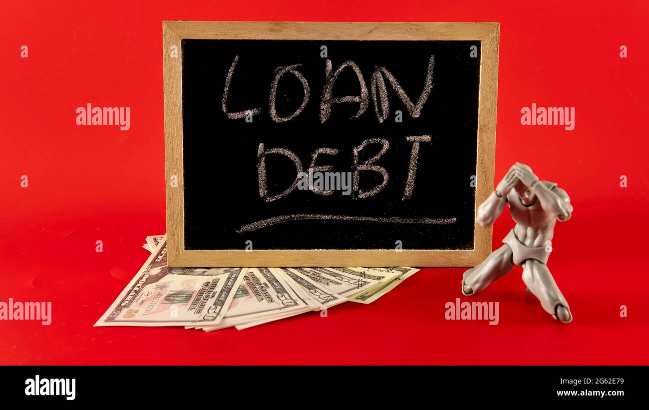 Financial problem concept. Loan Debt Concept. Selective focus on the board hand written loan debt Stock Photo