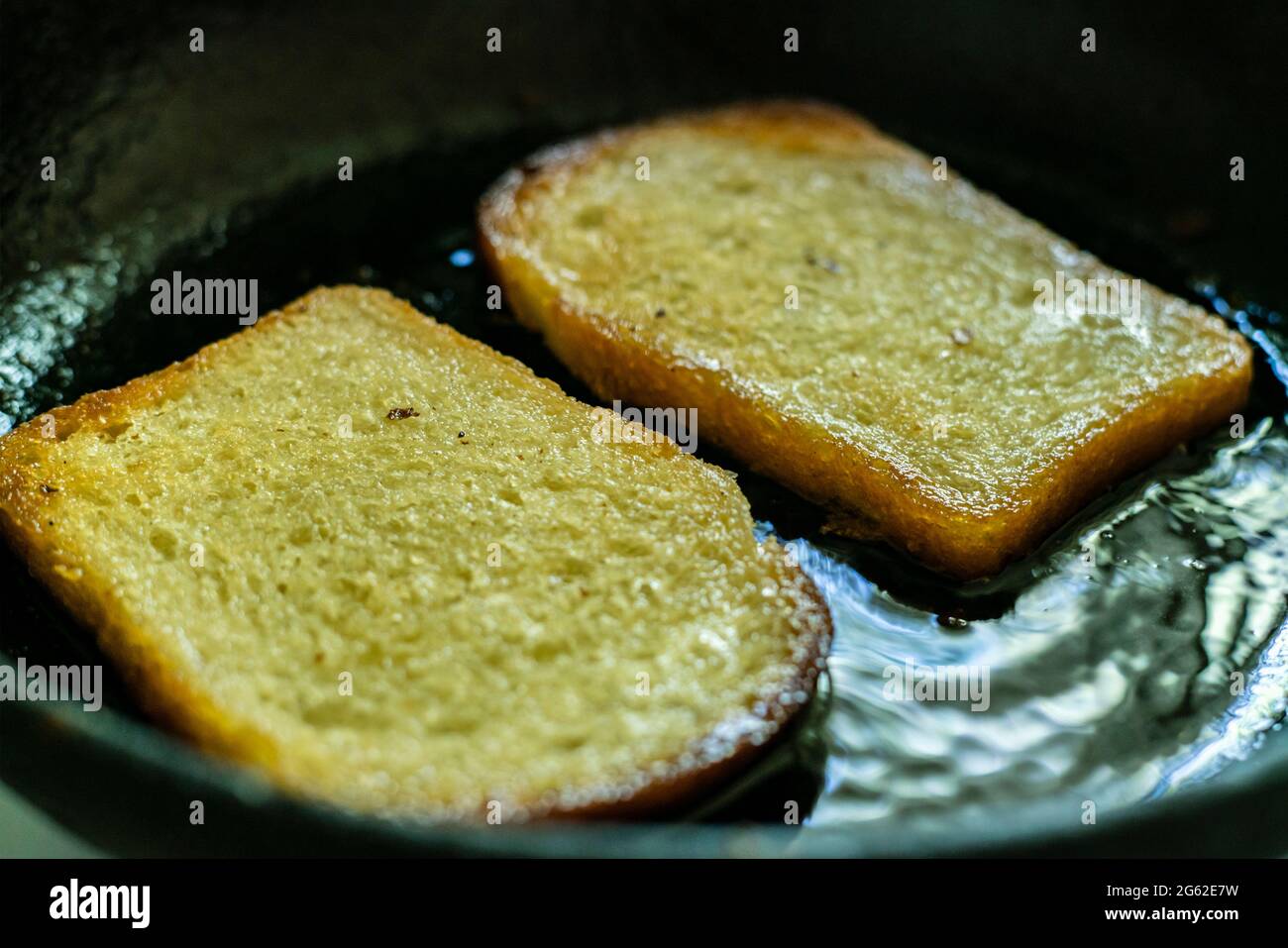 top view of frying bread toasts in the pan, the process of cooking fast