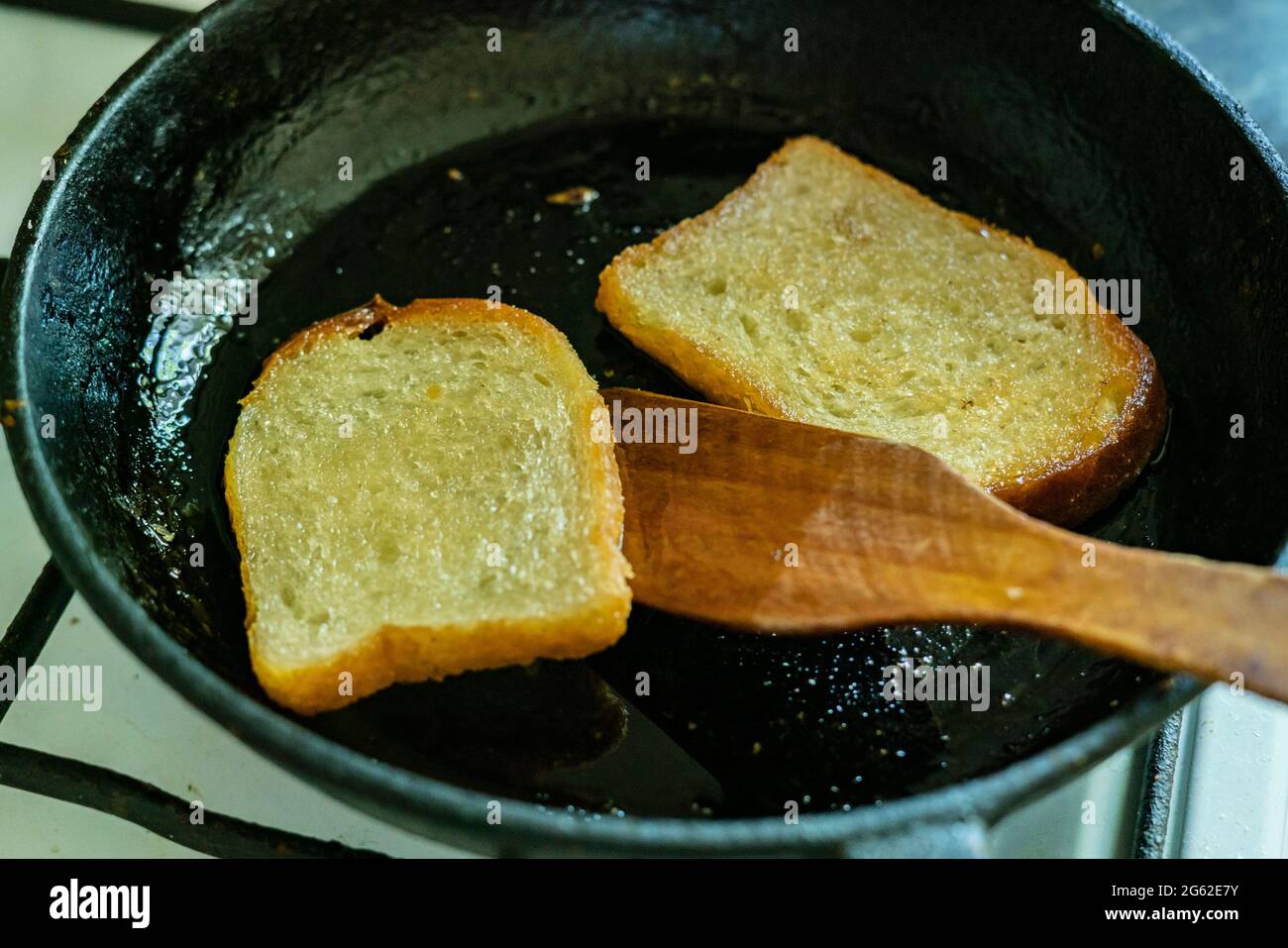 top view of frying bread toasts in the pan, the process of cooking fast