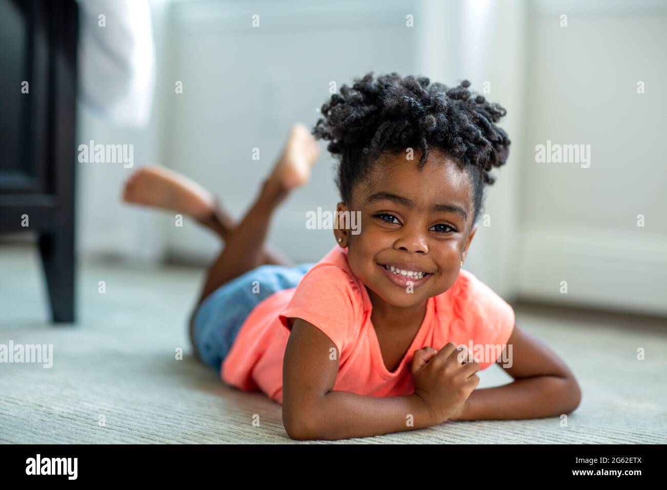 Cute little African American girl smiling and laughing Stock Photo - Alamy