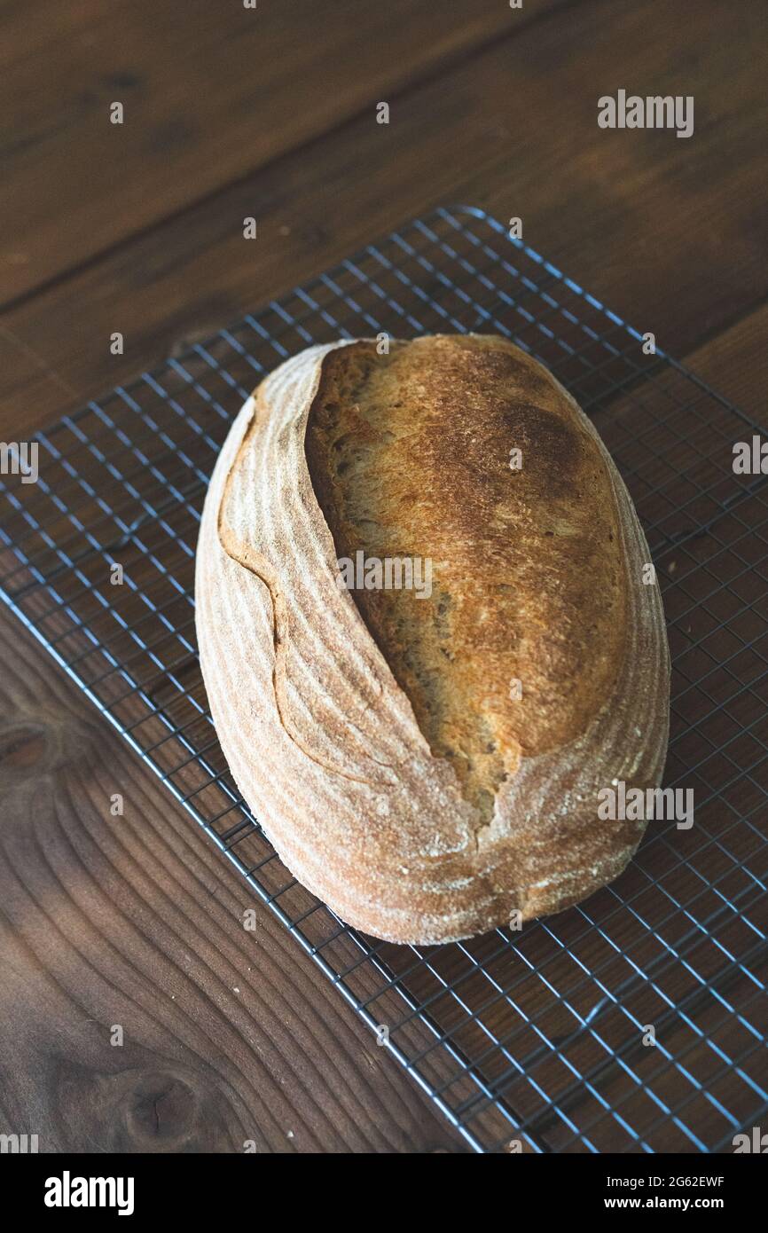 Homemade sourdough bread artisan freshly baked on a cooling rock wood table background top view Stock Photo