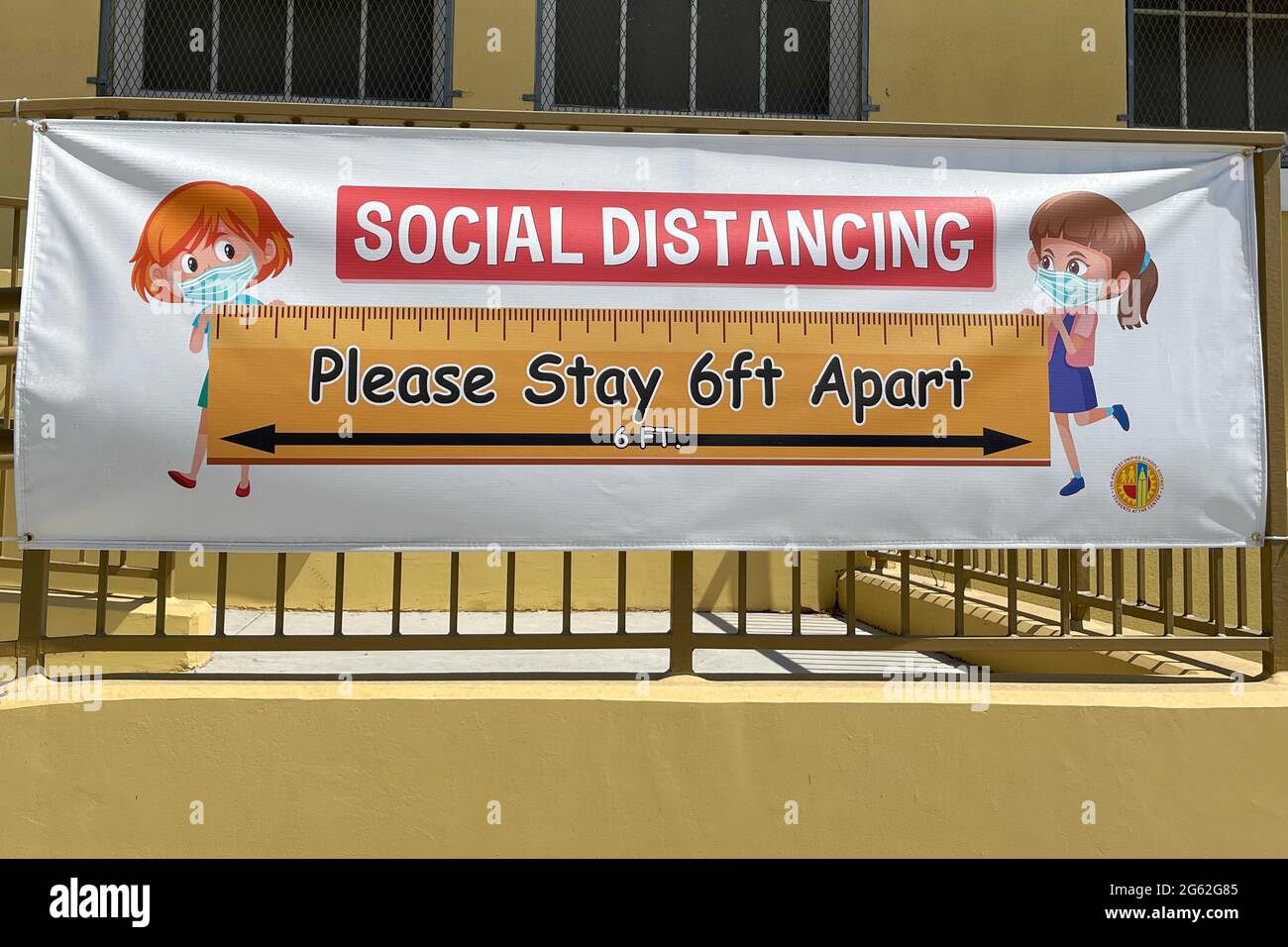 A social distancing sign with coronavirus COVID-19 safety precautions at Morris K. Hamasaki Elementary School, Thursday, July 1, 2021, in Los Angeles. Stock Photo