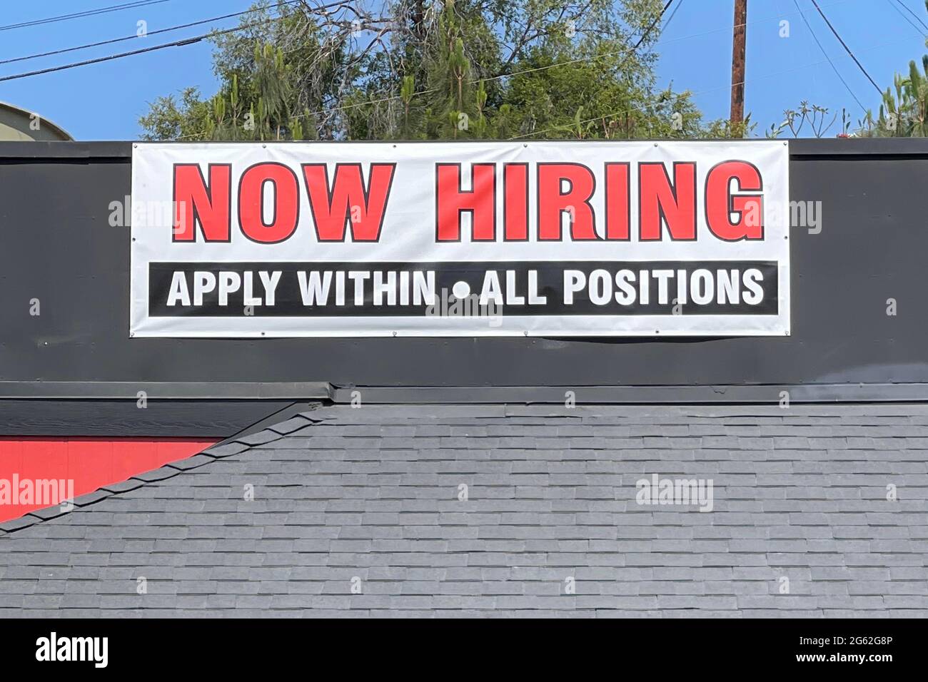A Now Hiring sign at Shakey's Pizza Parlor restaurant, Thursday, July 1, 2021, in Monterey Park, Calif. Stock Photo