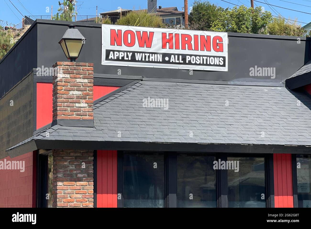 A Now Hiring sign at Shakey's Pizza Parlor restaurant, Thursday, July 1, 2021, in Monterey Park, Calif. Stock Photo