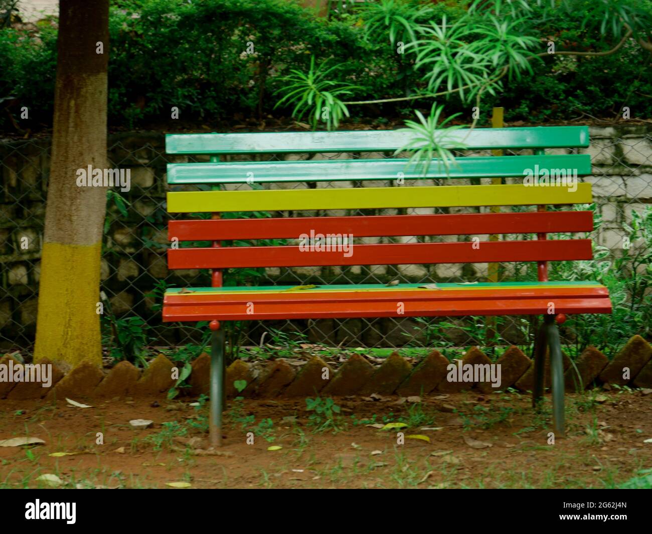 Metal colorful chair presented on natural green indian park background  Stock Photo - Alamy