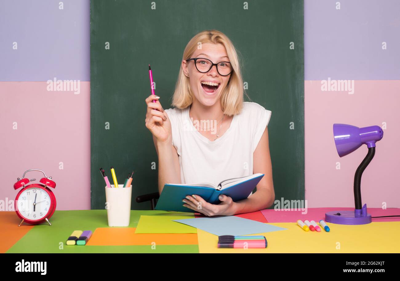 Female teacher at her desk marking students work. Pretty teacher ...