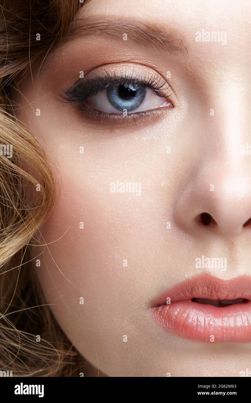 Closeup macro shot of blue human female eye. Woman with natural vogue face beauty makeup. Stock Photo