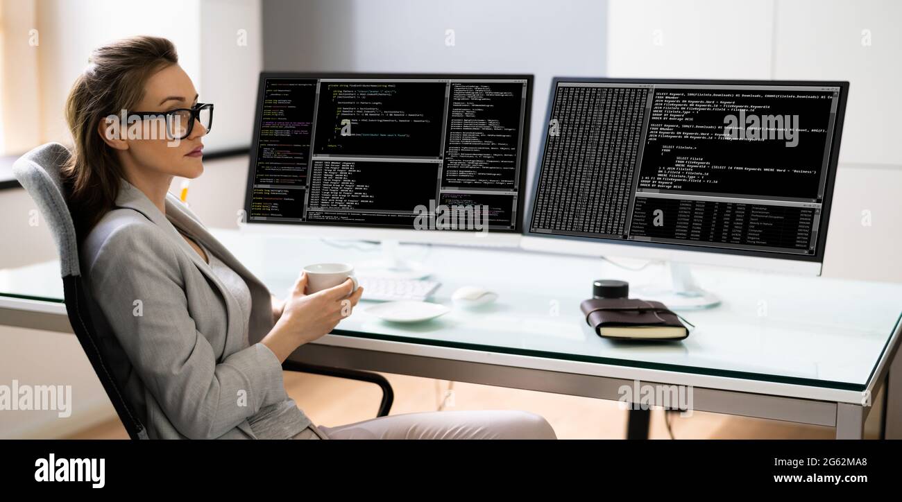 Programmer Woman Coding On Multiple Computer Screens Stock Photo - Alamy