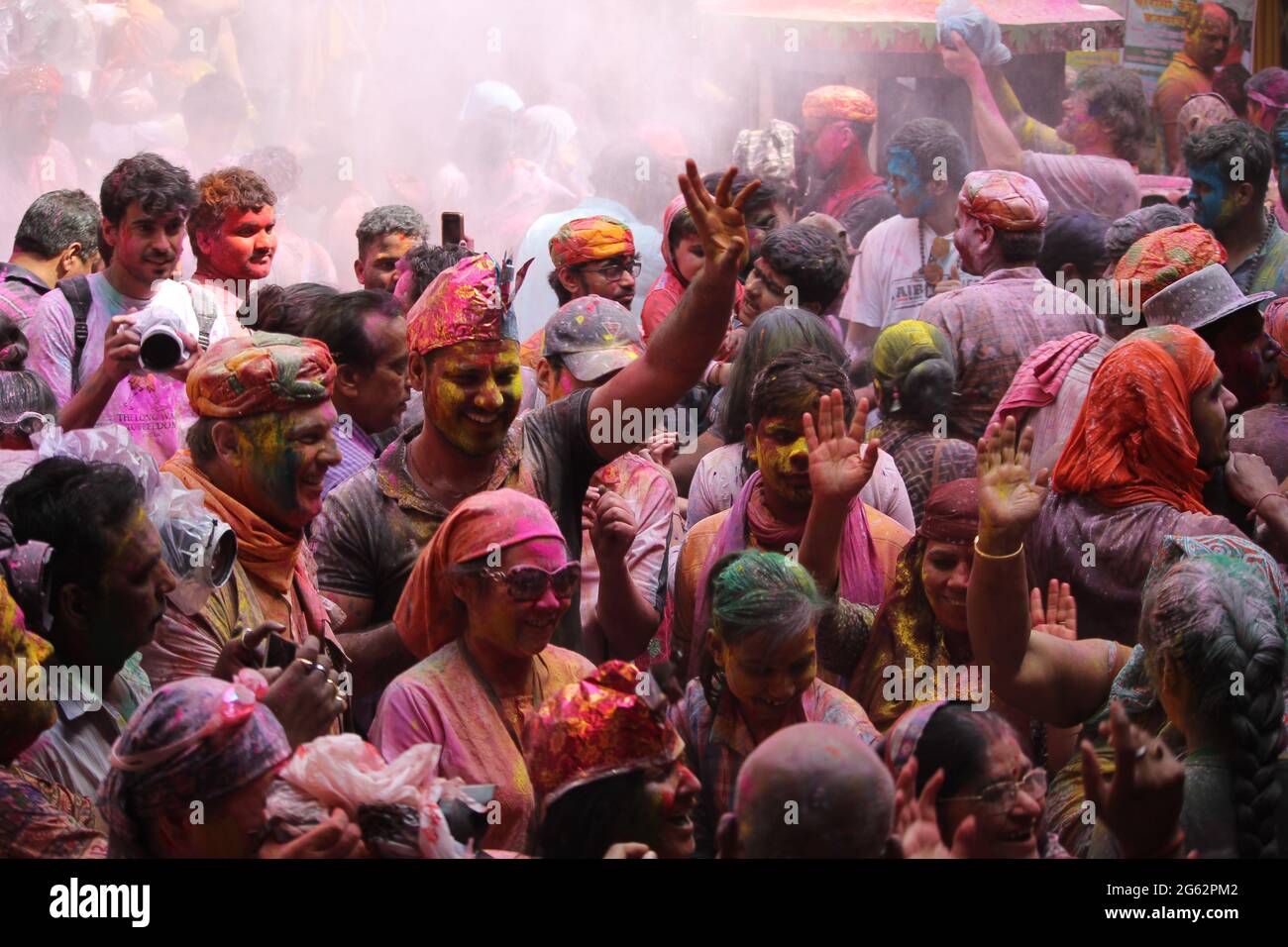 People celebrating the festival of colros - Holi in a temple at Dwarka, India. Stock Photo