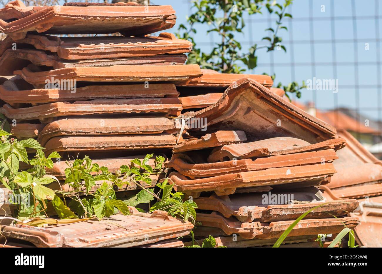 A pile of old tiles, removed from the roof of the house. Stock Photo