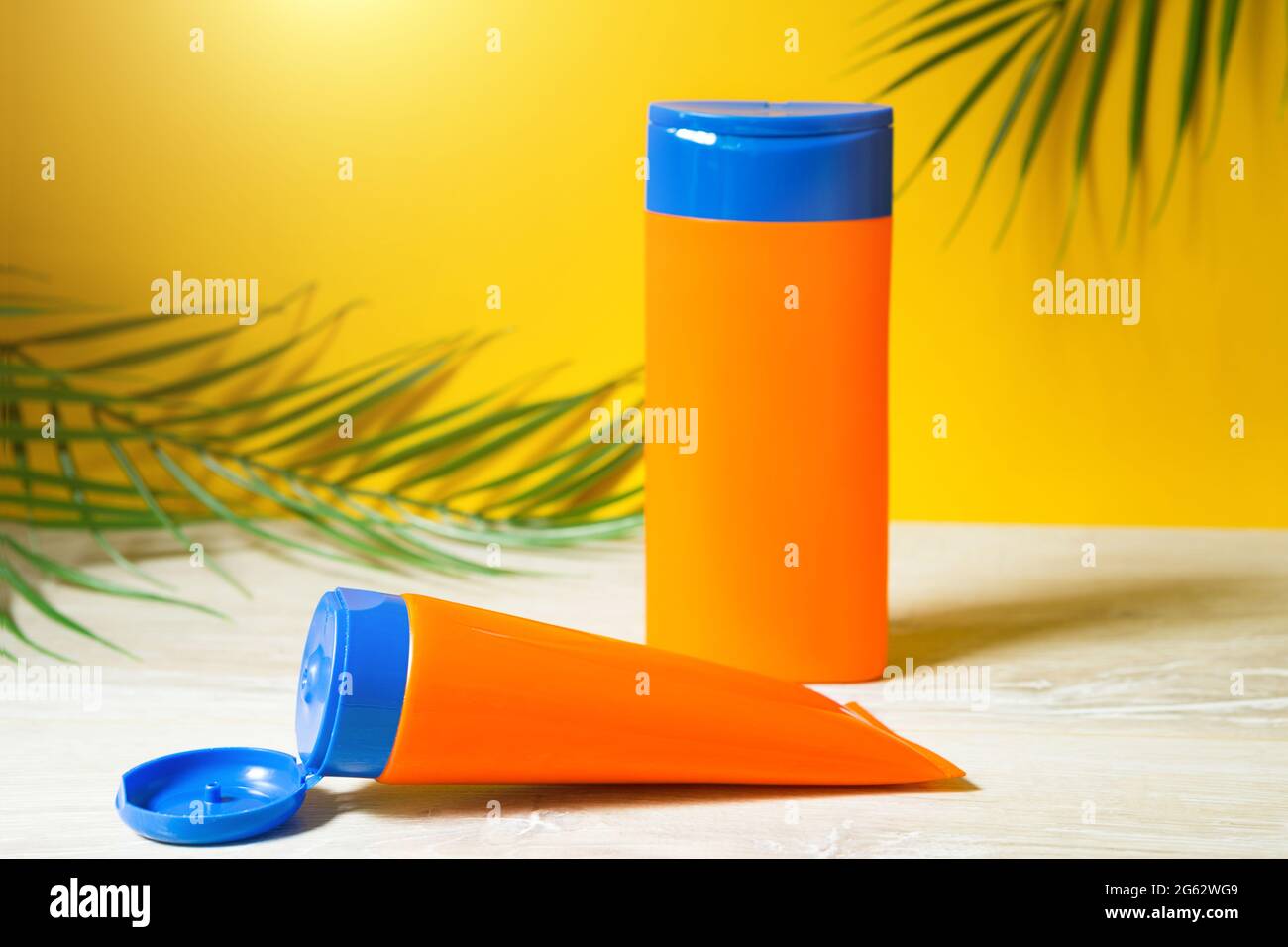 Spf Filter Tubes with mock up sunscreens on the table with yellow summer ...