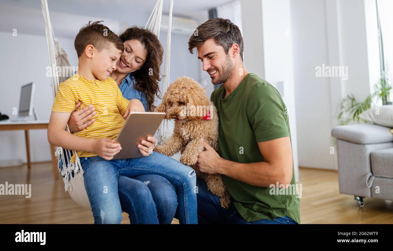 Happy modern family using computer together at home Stock Photo - Alamy